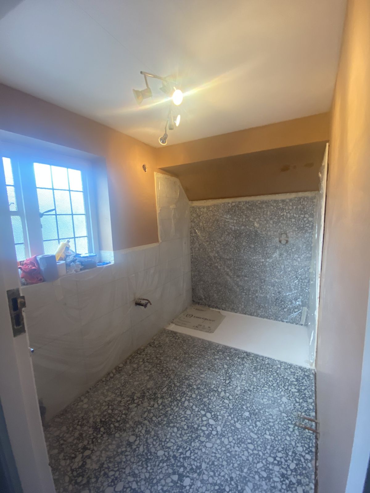 Freshly plastered shower room walls and ceiling