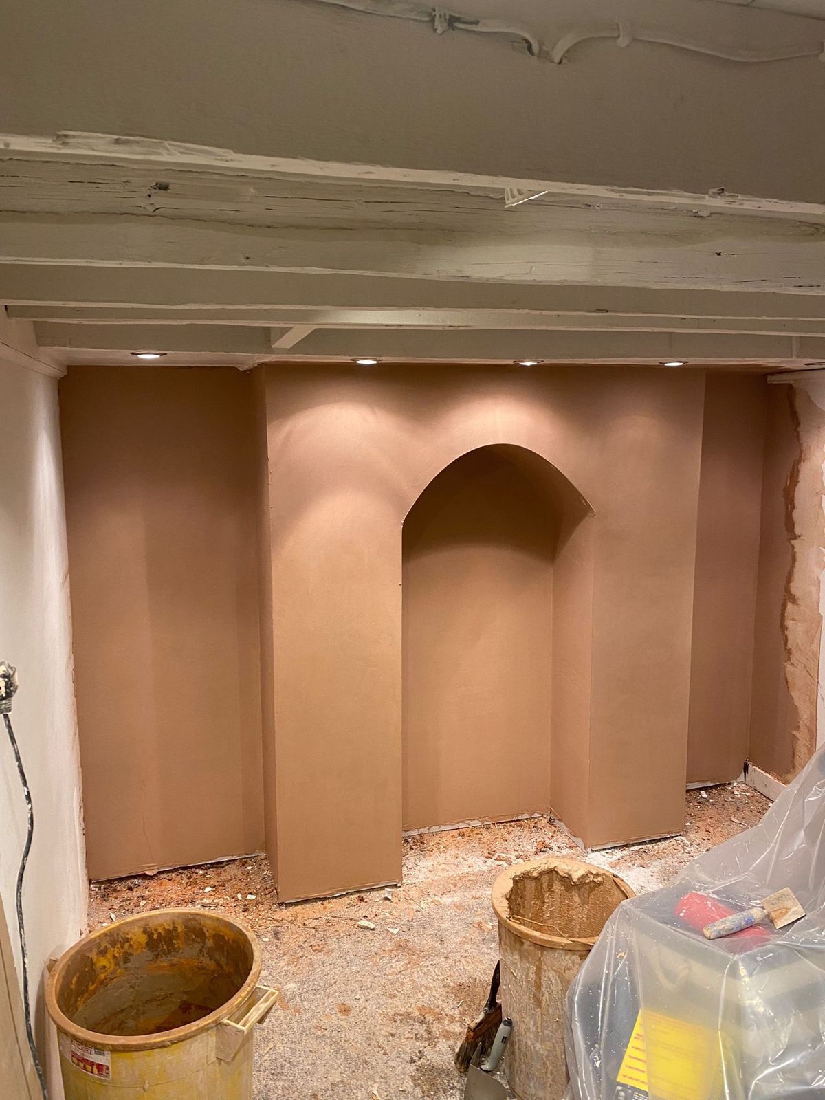 Freshly skimmed chimney breast with an arched alcove