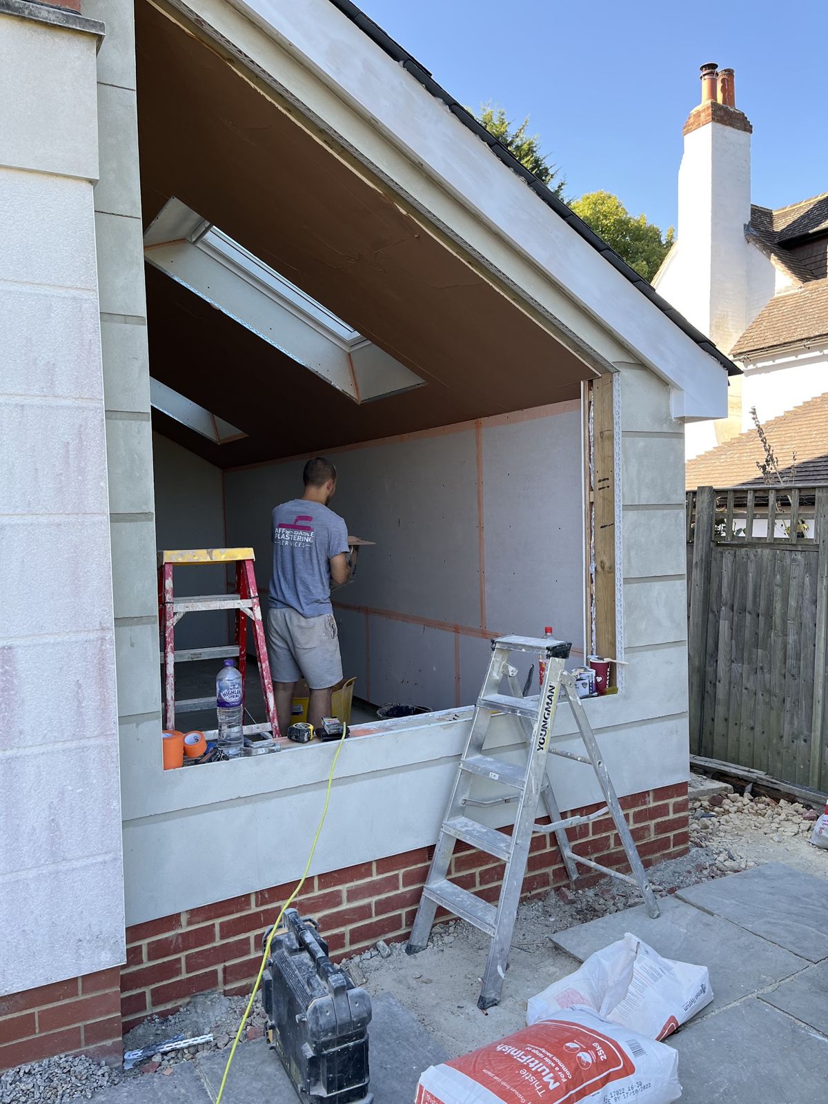 Extension being boarded inside with the outside wall rendered