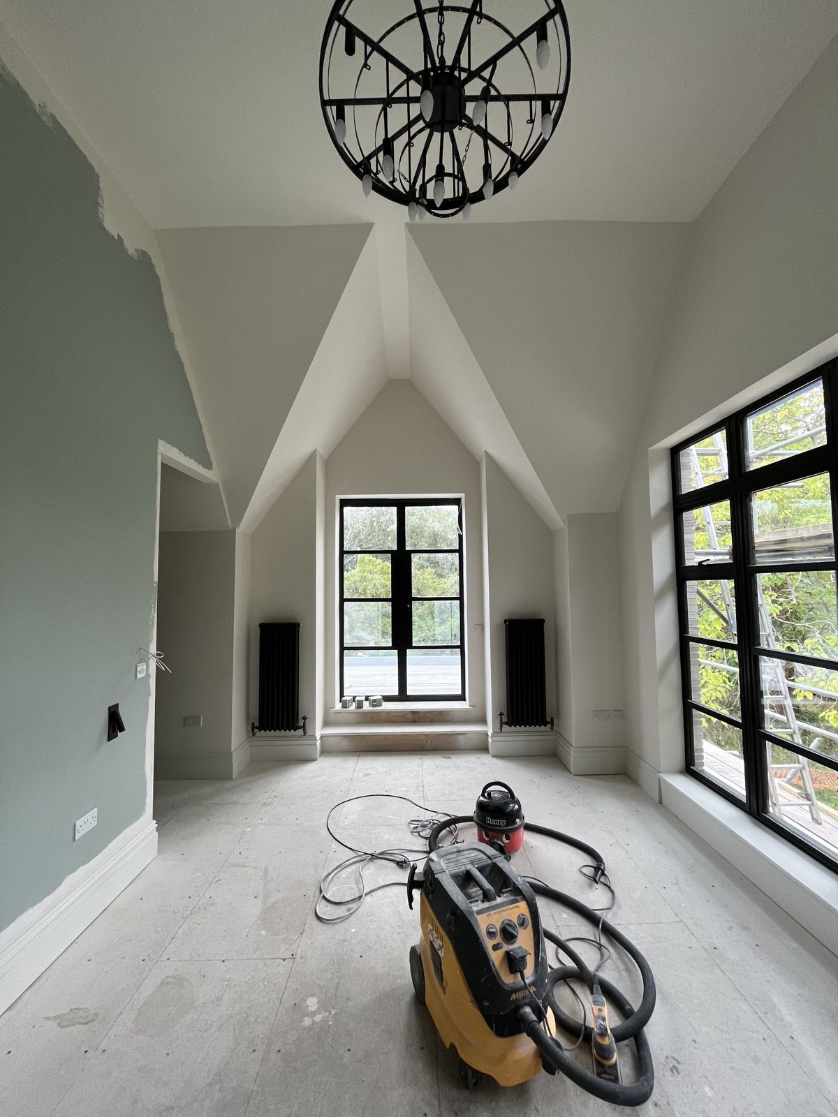 Finished vaulted bedroom with smooth plastered walls and ceiling