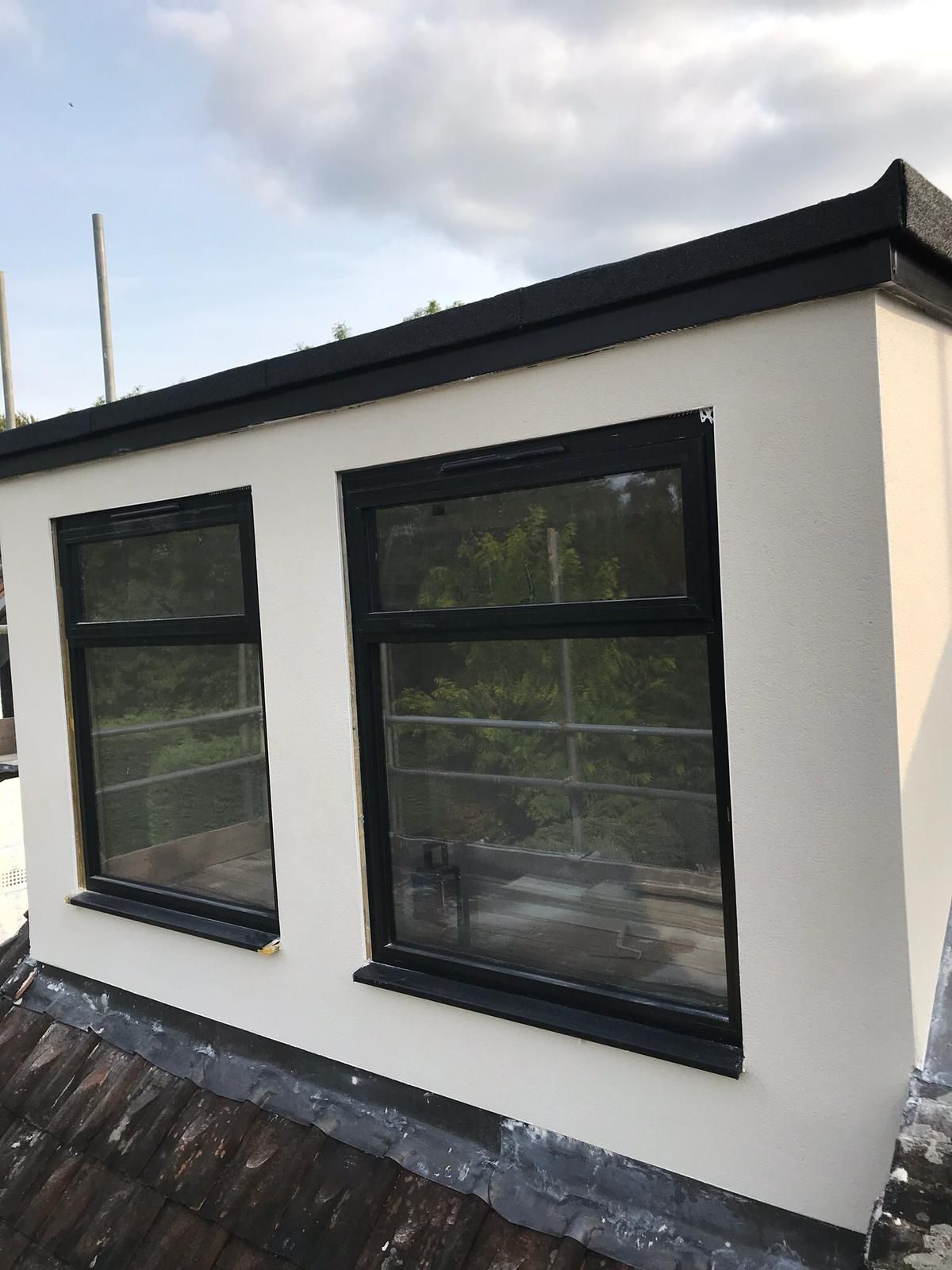 Single-storey extension finished in cream flat render